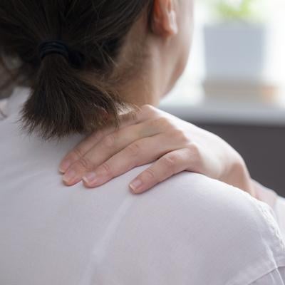 Woman suffering from stiff shoulders.