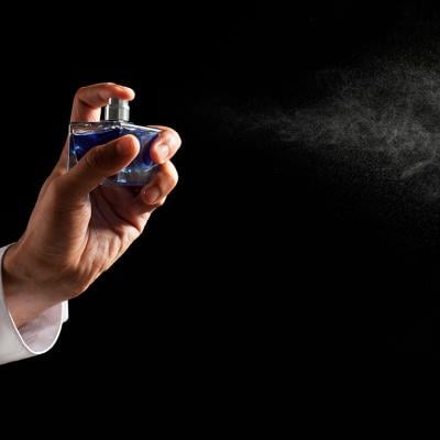 Luxury perfume being sprayed in the air.