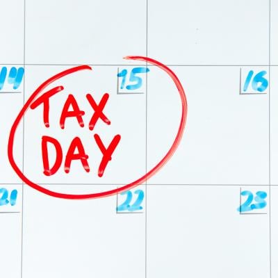 April 15th on a calendar encircled in red with a label 'Tax Day'.