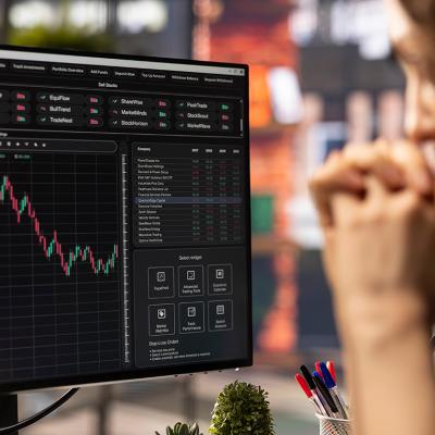 A business person analyzing financial charts using stock market visualization from a laptop.