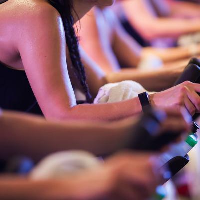 Close up on the intense sweat in the arms of bike spin class students.