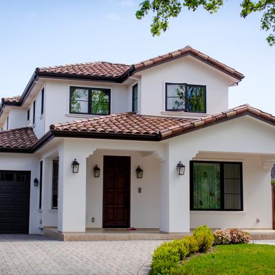 An American suburban residential house and a garage with landscaping.