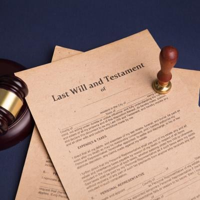 A notary's public pen and stamp on a last will and testament.