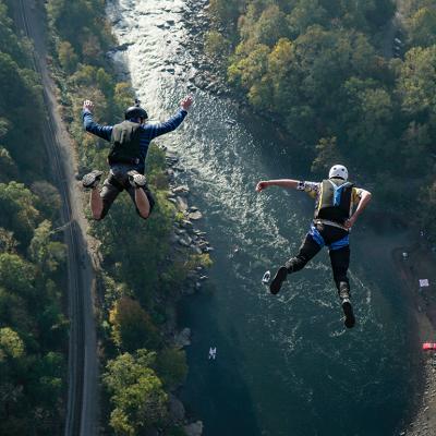 Two jumpers leap from New River Gorge Bridge in West Virginia.