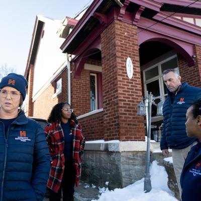 Members of Ohio's Hamilton County Quick Response Team, which helps people who use fentanyl get treatment, stand outside a brick home with snow on the ground.  Ohio had the largest drop in opioid overdose deaths of any state as of October 2025.