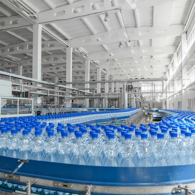 Massive production of plastic bottles on factory's conveyor belt.