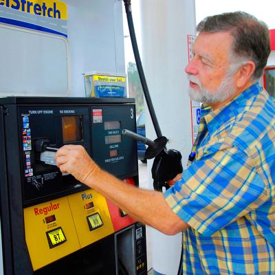 A man pays for gas at a station with credit card.