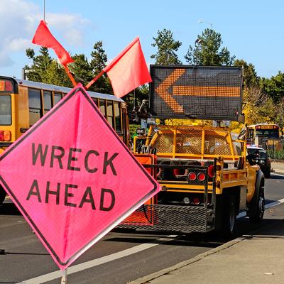 A 'wreck ahead' sign at a truck rollover accident.