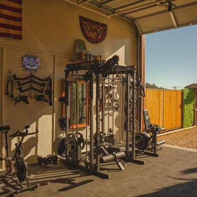 Gym equipment set up in a home's garage.