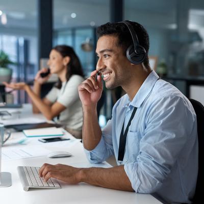 A happy male customer service representative in a call.