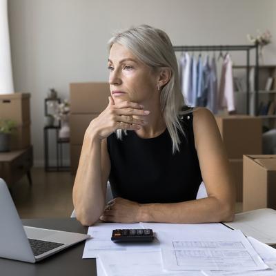 A business person thinking of finances at a home office. 