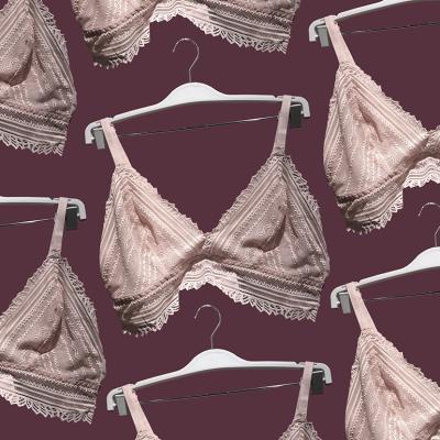 Pink lace unlined bras on a hanger.