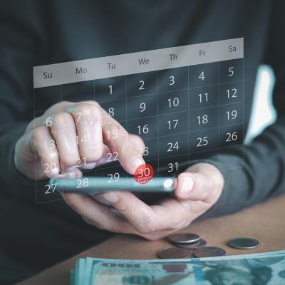 A person using a smartphone to check a virtual calendar.