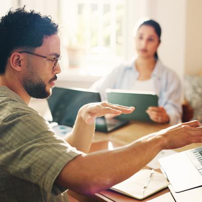 Teammates coworking during a conversation on cash management.