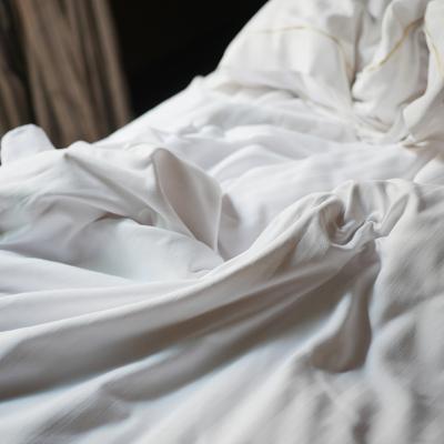Soft white bedding on a cozy bed.