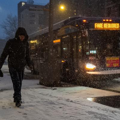 A person walks along the snowy street in New York City, USA.