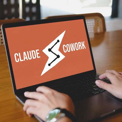 A person using the Claude Cowork platform while working at a cafe.