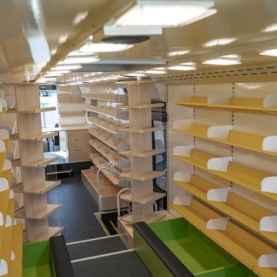 Interior of a modern bus converted into a small library.