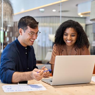 Coworkers working together on a task in an office.