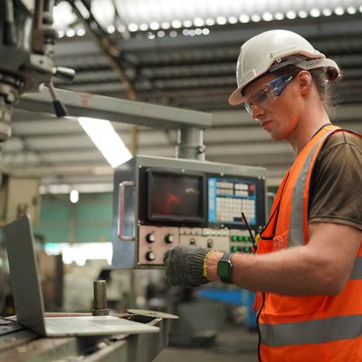 An industrial engineer working inside a manufacturing factory.