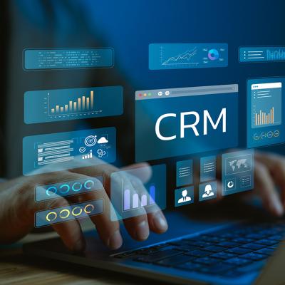 A data analyst utilizing CRM (Customer Relationship Management) system and dashboard from a work laptop.