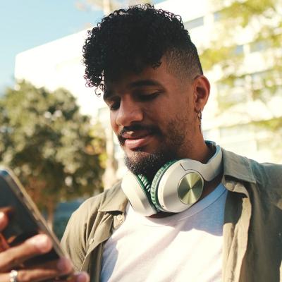 A young man checking phone outdoors.