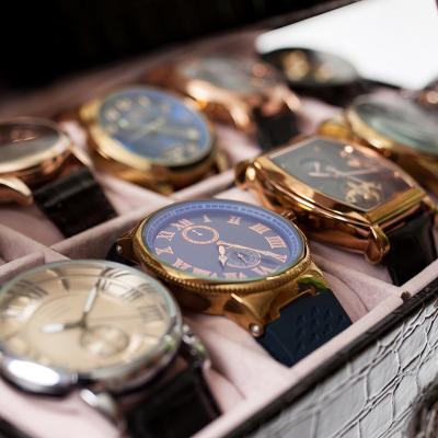 A set of men's luxury wrist watches in a storage box.