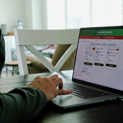 Man at home trying to buy a sports tournament ticket online.