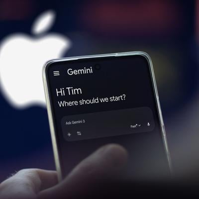 The Gemini app on a phone, with a blurred logo of Apple in the background.