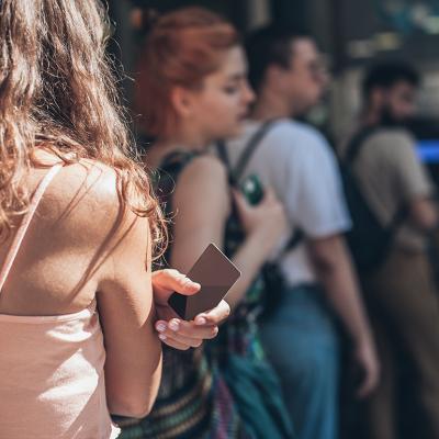 A queue of people waiting to withdraw money from an ATM. 