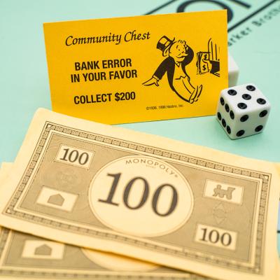 Banknotes and a bank error card from the Monopoly board game.