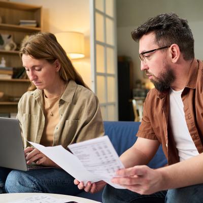 Couple at home organizing tax documents.