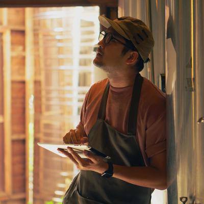 A male business owner checking craft brewery factory systems.