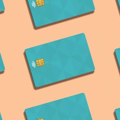 Teal credit cards against a peach background.