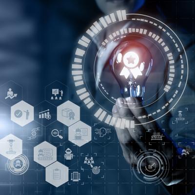 Concept of AI and quality management software graphics around a person holding a lightbulb.