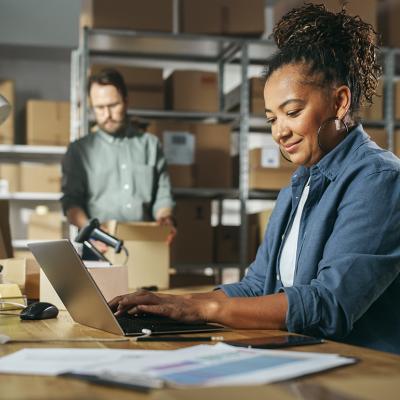 Retail managers check inventory stocks in a warehouse. 