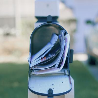 An opened mail box full of letters.
