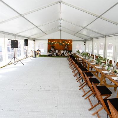 An events tent set up with a long table for a festival.