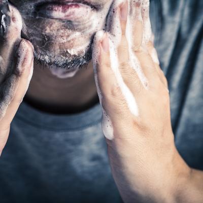 A man washing his face.
