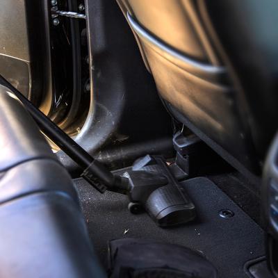 A vacuum cleans the interior of a car.