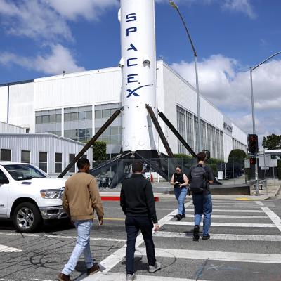 People walk outside a SpaceX facility in Hawthorne, California.