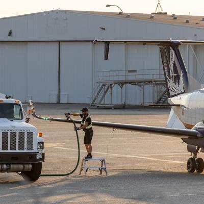 Aircraft staff refuels a private plane.