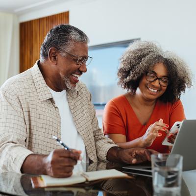 An elderly couple planning their budget and finances at home.