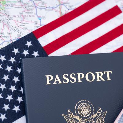 A U.S. passport on top of a U.S. flag and travel map.