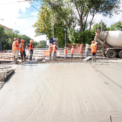 Construction workers doing road works and tram tracks repair. 