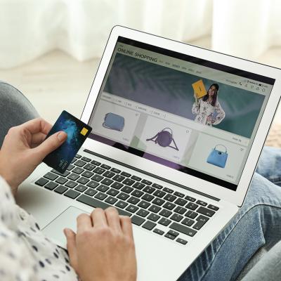 A person using a credit card as payment method for online shopping. 