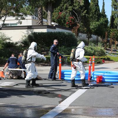 Hazardous materials team cleaning up a truck and chemicals accident on the road.