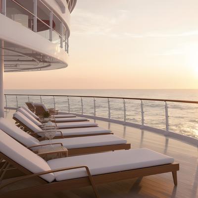 Lounge chairs on a ship deck facing the ocean's horizon during sunset.