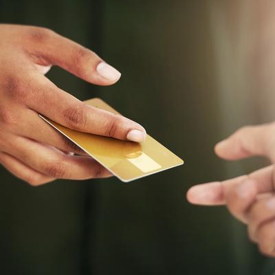 Person handing out a credit card.