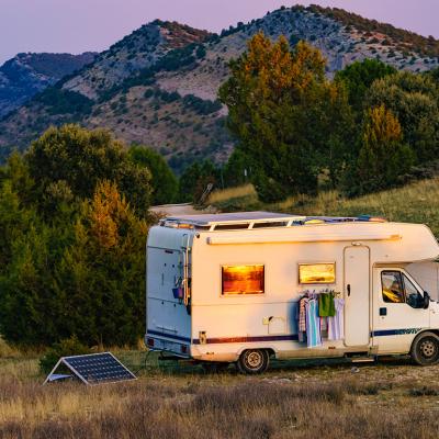 A motorhome recreational vehicle (RV) parked in a mountain for a holiday camping.